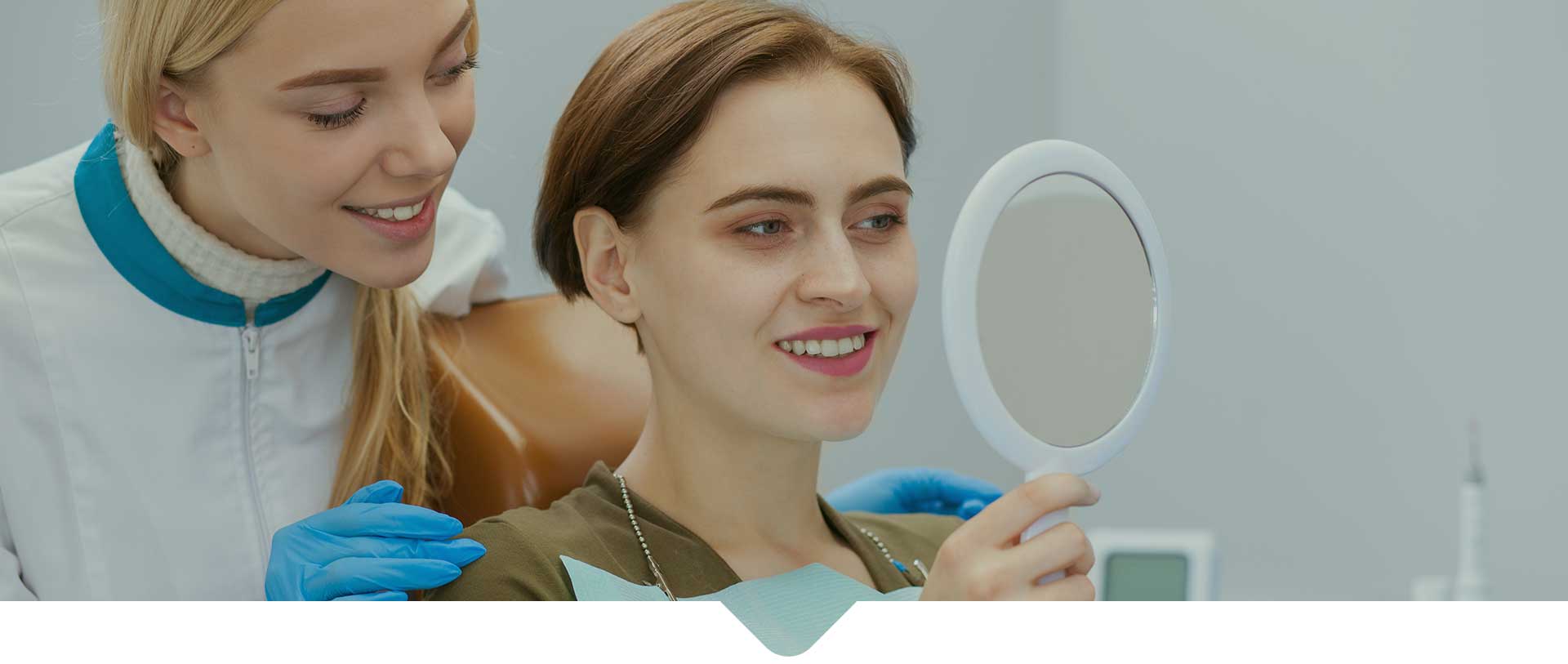 Professional dentist and her client examining results of medical teeth treatment.