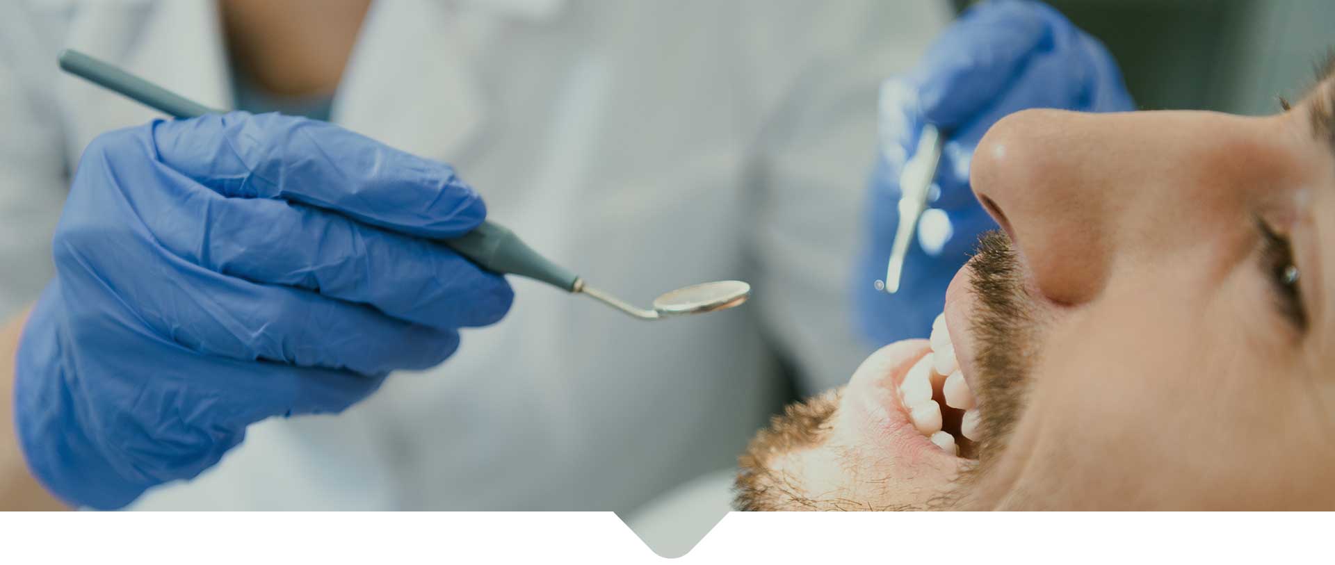 A male patient getting dental examination at the dentist