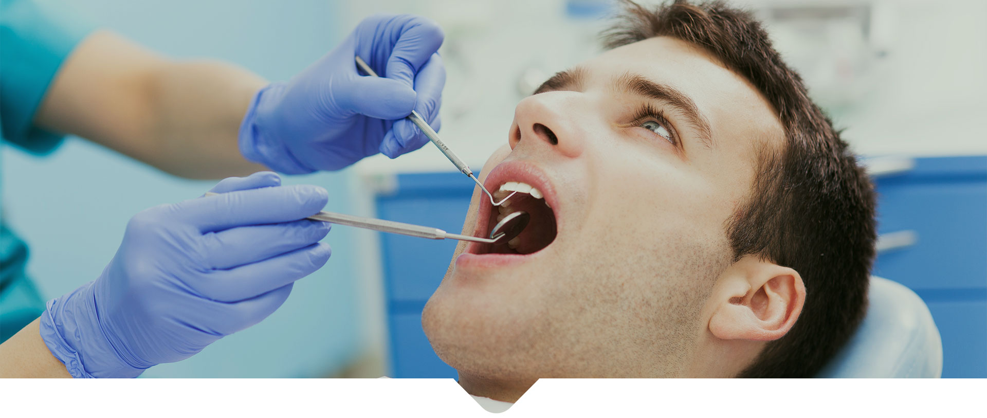 A Male patient having his teeth examined at dentist's